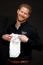 <p>Prince Harry is presented with an Invictus Games baby grow for his newborn son Archie.</p>