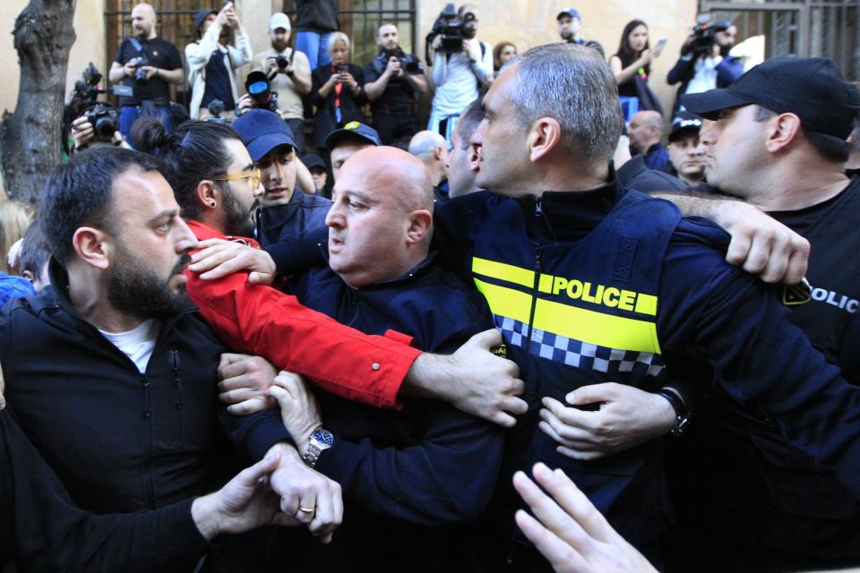 Police block protesters gathered outside the parliament building in Tbilisi, Georgia, on Tuesday, April 16, 2024, to protest against "the Russian law" similar to a law that Russia uses to stigmatize independent news media and organizations seen as being at odds with the Kremlin. (AP Photo/Shakh Aivazov)