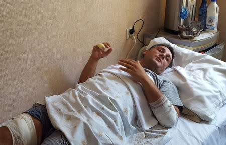 Samir Bayramov, 38, a policeman wounded during protests, speaks to media in a hospital in Ganja, Azerbaijan, July 12, 2018. REUTERS/Staff