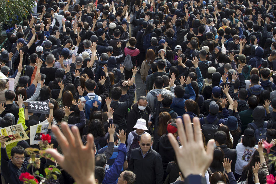 Participants raise their hands to show five demands during a rally demanding electoral democracy and call for boycott of the Chinese Communist Party and all businesses seen to support it in Hong Kong, Sunday, Jan. 19, 2020. Hong Kong has been wracked by often violent anti-government protests since June, although they have diminished considerably in scale following a landslide win by opposition candidates in races for district councilors late last year. (AP Photo/Ng Han Guan)