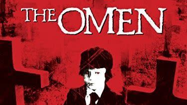 the poster for the classic horror film the omen, featuring a child walking among tombstones