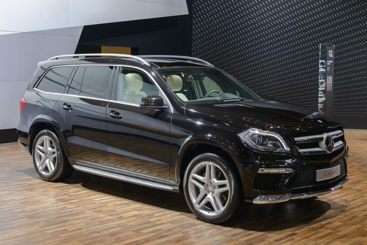 Brussels, Belgium - January 14, 2014: Mercedes-Benz GL-Class SUV on display at the 2014 Brussels motor show. People in the background are looking at the cars.