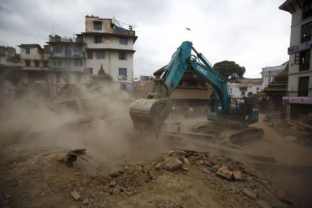 An excavator digs the rubble to search for the bodies after an earthquake hit, in Kathmandu, Nepal April 25, 2015. REUTERS/Navesh Chitrakar