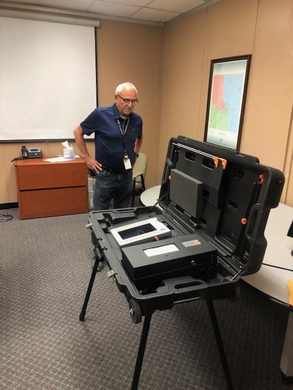 Last year Delaware County Clerk Rick Spangler examines one the voting machines that have been in use the past 20 years. The county is buying new machines that will go into use for the 2024 primary election next spring.