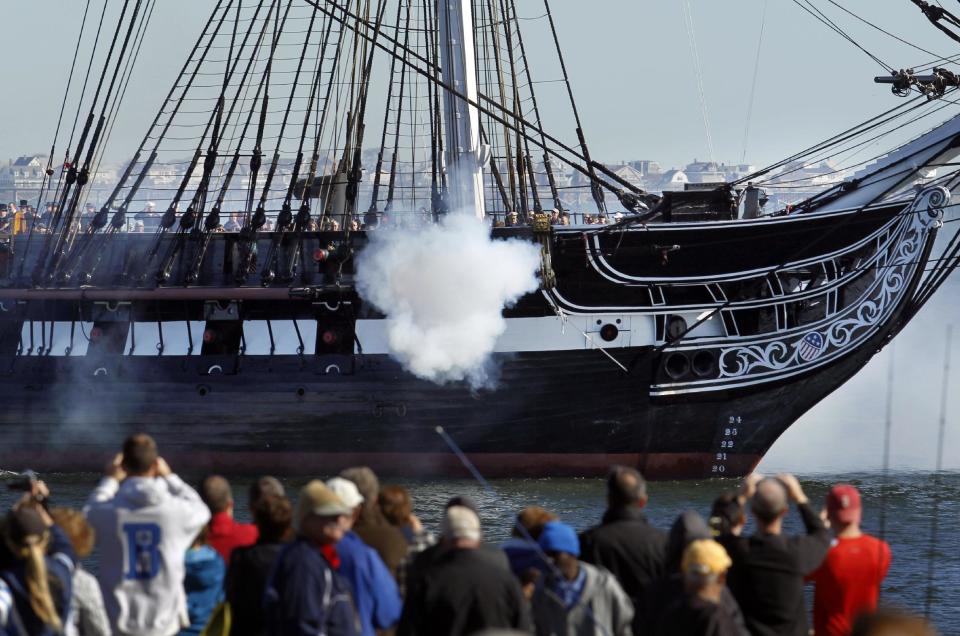 In this Friday, Oct. 21, 2011 file photo, the USS Constitution, which was an important vessel in the U.S. fleet during the War of 1812, fires guns in Boston Harbor as people watch from the shore, in Boston. The ship can be visited in Charlestown, Mass. Events marking the bicentennial of the War of 1812 are taking place around the country. (AP Photo/Steven Senne, File)