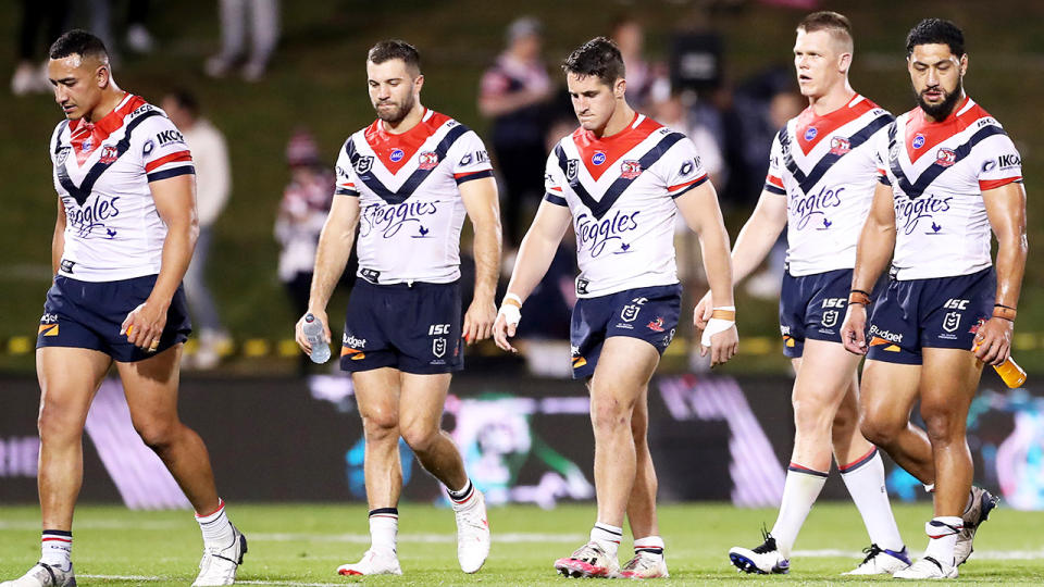 Sydney Roosters players are pictured walking off the field after their loss to Penrith.