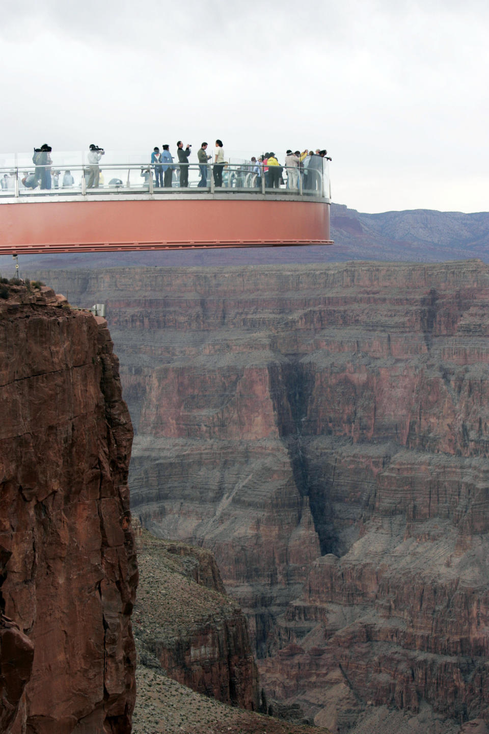 FILE - This March 20, 2007 file photo shows people walking on the Skywalk during the First Walk event at the Grand Canyon on the Hualapai Indian Reservation at Grand Canyon West, Ariz. David Jin the Chinese tour operator and Las Vegas businessman and who built this Grand Canyon Skywalk attraction in northwestern Arizona has died in Los Angeles. A Grand Canyon Skywalk Development spokesman said that Jin died Thursday June 13, 2013 at UCLA Medical Center after a four-year battle with cancer. He was 51.(AP Photo/Ross D. Franklin, file)