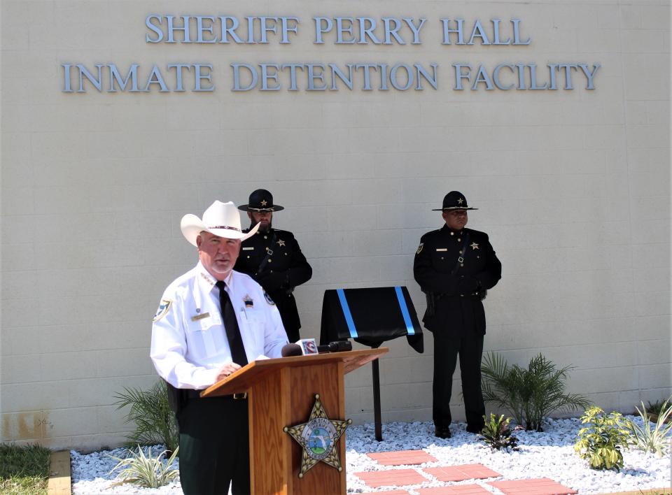 Flagler County Sheriff Rick Staly dedicates a plaque Wednesday, May 8, 2024, in honor of Sheriff Perry Hall, the first law enforcement officer killed in the line of duty in Flagler County. He died in 1927.