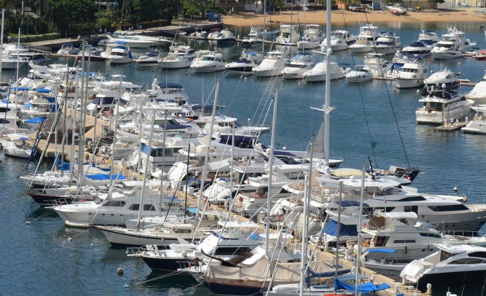 In this Tuesday, Jan. 7, 2014 photo, yachts are docked at a marina in the Bay of Acapulco, Mexico. After inspecting more than 1,600 vessels in late November, the Mexican government’s Treasury Department announced it had initiated seizure orders against hundreds of foreign boats it accused of lacking a temporary import permit which proves that the holders own their boats and promise not to leave them in Mexico or sell them here. Many boat owners say they simply weren’t around when authorities came by and slapped liens on the boats barring them from leaving Mexico, and say officials have not told them how they could remedy the situation. Foreign pleasure boat owners call this a heavy-handed crackdown over a minor permit, and they say it threatens a tourism sector Mexico has long sought to promote. (AP Photo/Bernandino Hernandez)