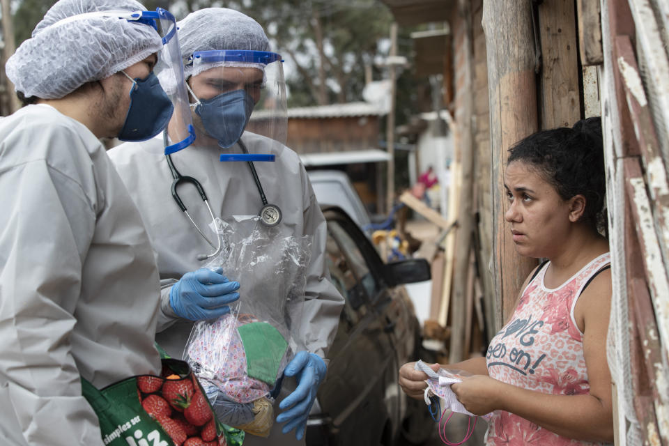 Health workers from Doctors Without Borders visit a squatters camp to conduct medical examinations and avoid the spread of the COVID-19 in Sao Bernardo do Campo, greater Sao Paulo area, Brazil, Wednesday, June 3, 2020. (AP Photo/Andre Penner)