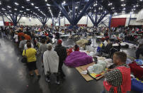 <p>People line up for food and others rest at the George R. Brown Convention Center that has been set up as a shelter for evacuees escaping the floodwaters from Tropical Storm Harvey in Houston, Texas, Tuesday, Aug. 29, 2017. (Photo: LM Otero/AP) </p>