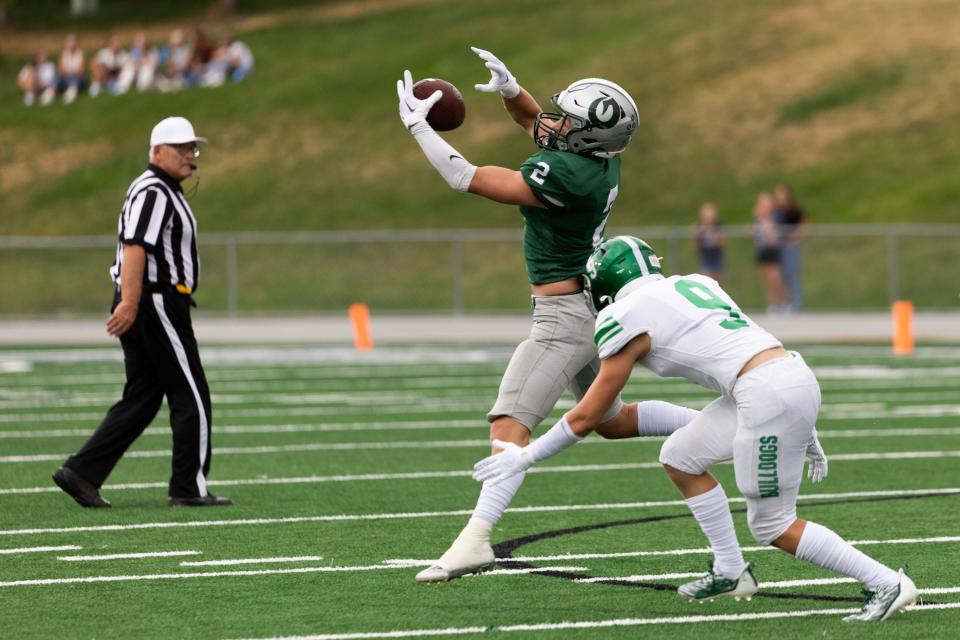 Olympus’s Ty Seagle catches the ball with Provo’s Jacob Luke on the tackle in the football game at Olympus High School in Holladay on Friday, Aug. 18, 2023. | Megan Nielsen, Deseret News