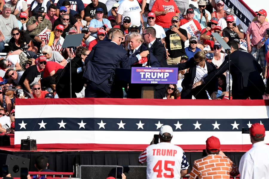 Former US President Donald Trump is surrounded by Secret Service agents during a campaign event at Butler Farm Show Inc. in Butler, Pennsylvania, US, on Saturday, July 13, 2024. Former President Donald Trump is being evaluated at a medical facility but is “fine” after an incident where he was rushed off stage during rally in Butler, Pennsylvania, his campaign said. Photographer: Joe Appel/Bloomberg via Getty Images