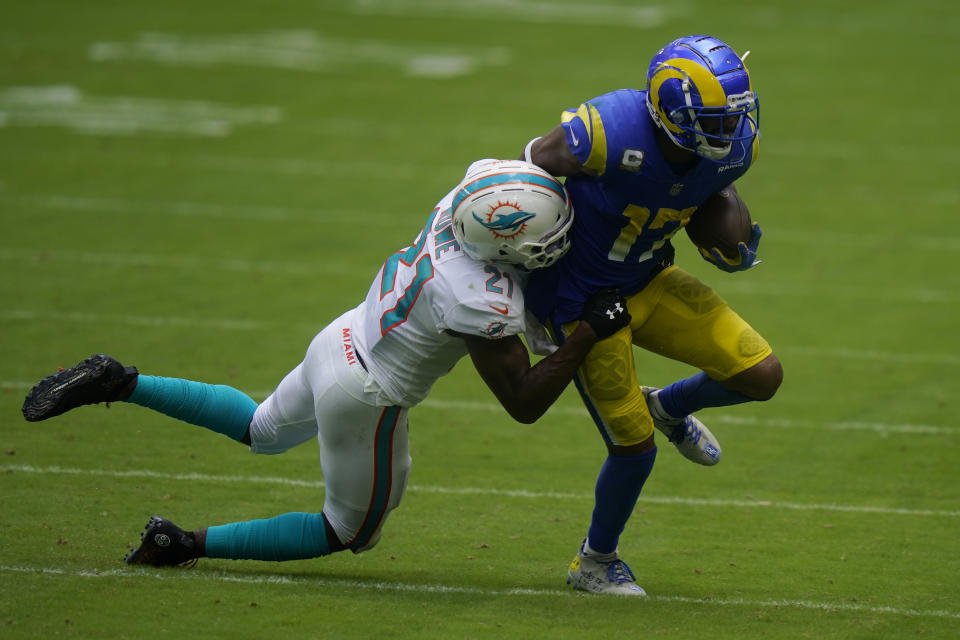 Miami Dolphins free safety Eric Rowe (21) tackles Los Angeles Rams wide receiver Robert Woods (17), during the first half of an NFL football game, Sunday, Nov. 1, 2020, in Miami Gardens, Fla. (AP Photo/Lynne Sladky)