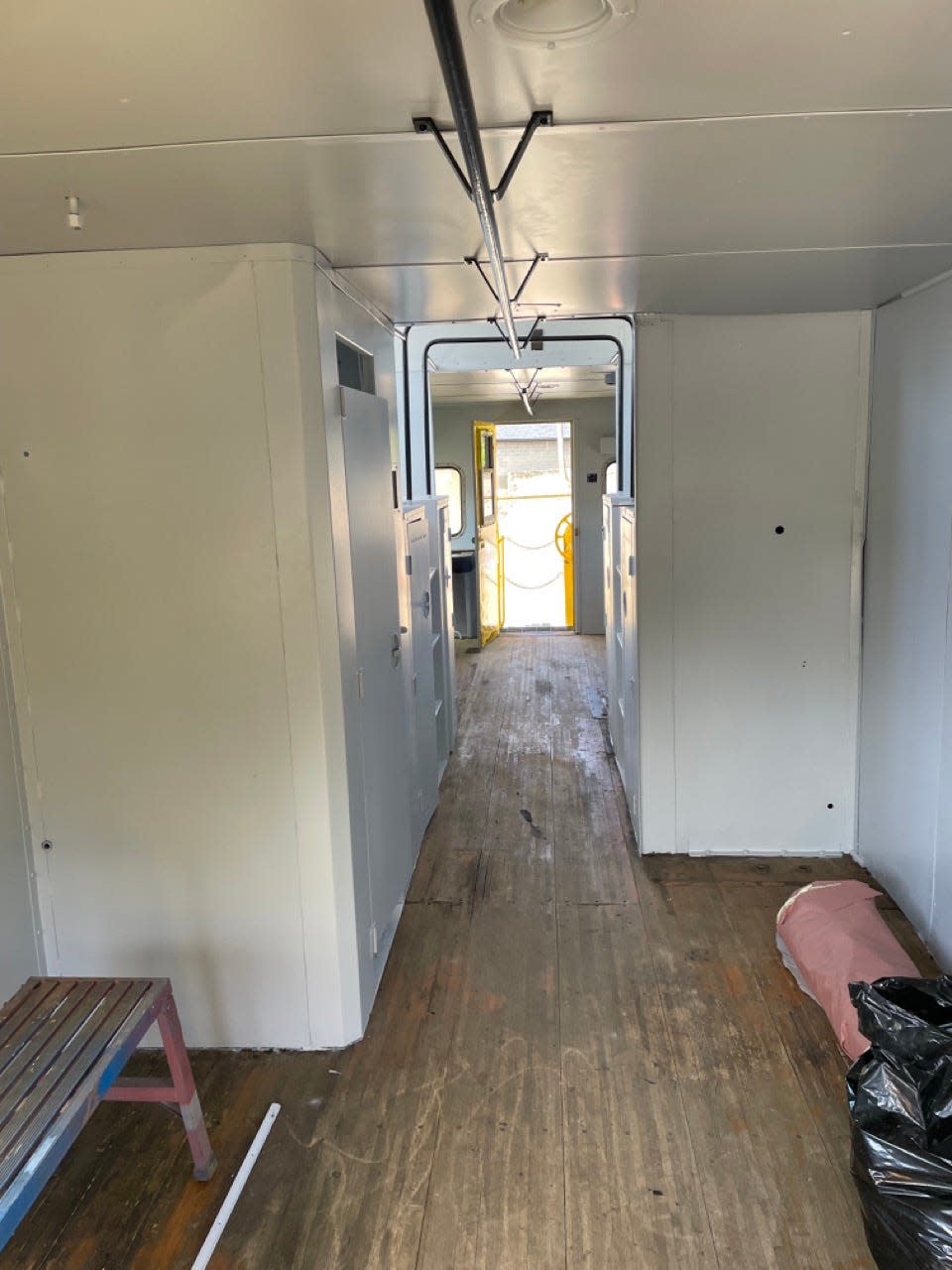 Newly painted white walls and oak flooring inside the Chessie System caboose.