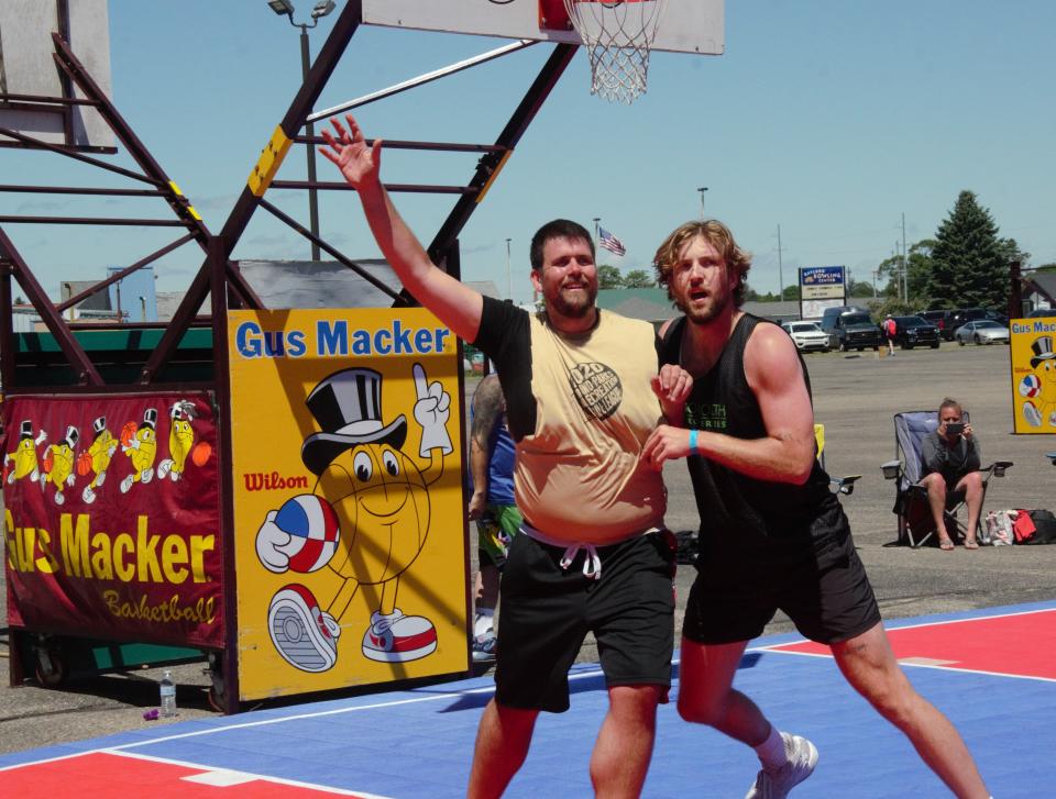Go North's Joey Brunk (right), former college basketball player for Butler, Indiana and Ohio State University plays defense during the Gus Macker Top Men's championship on Sunday, June 26 at the Otsego County Sportsplex in Gaylord.