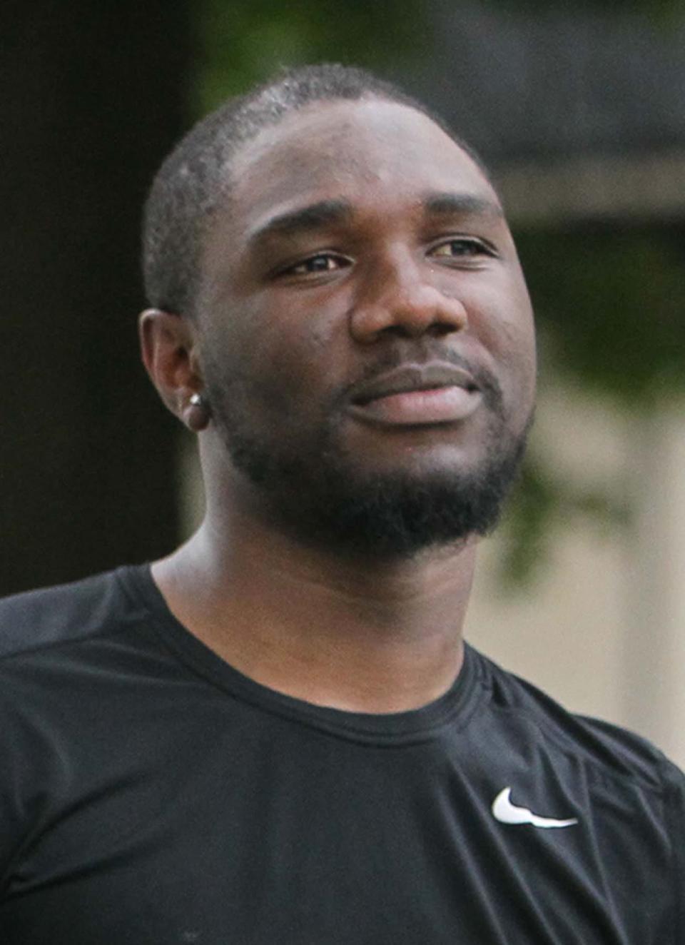 Emmanuel Sese, a coach during the 15th annual free summer soccer camp put on by the Akron Inner City Soccer Club at Hardesty Park in Akron, watches the children play soccer on Monday. See began playing with Inner City Soccer when he was an 8-year-old boy who had just moved to Akron from Nigeria.