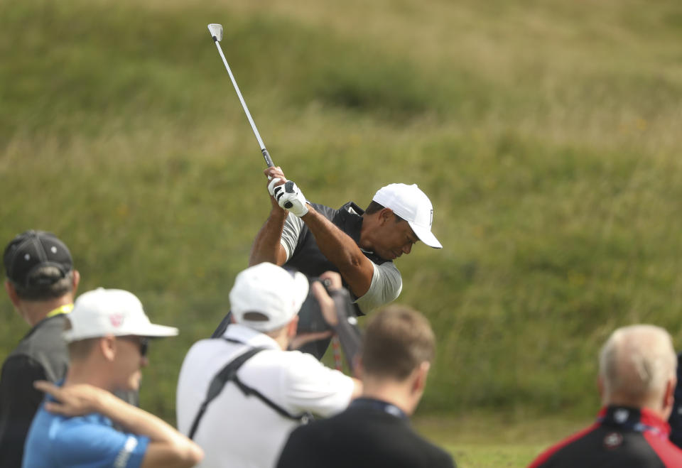 Tiger Woods of the United States plays a shot at the practice ground ahead of the start of the the British Open golf championships at Royal Portrush in Northern Ireland, Tuesday, July 16, 2019. The British Open starts Thursday. (AP Photo/Jon Super)