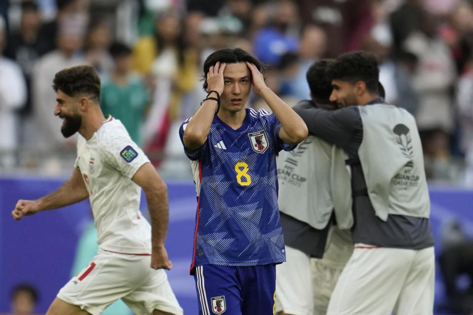 Japan's Takumi Minamino reacts after their team lost the Asian Cup quarterfinal soccer match between Japan and Iran at Education City Stadium in Al Rayyan, Qatar, Saturday, Feb. 3, 2024. (AP Photo/Aijaz Rahi)