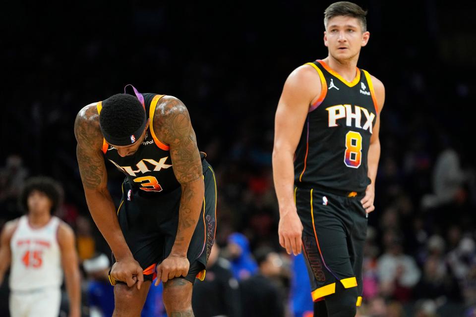 Phoenix Suns guard Bradley Beal (3) looks downward after an injury against the New York Knicks during the first half of an NBA basketball game, Friday, Dec. 15, 2023, in Phoenix.