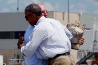 U.S. President Barack Obama embraces Louisiana Governor John Bel Edwards as he arrives aboard Air Force One at Baton Rouge Metropolitan Airport in Baton Rouge, Louisiana, U.S., August 23, 2016. REUTERS/Jonathan Ernst