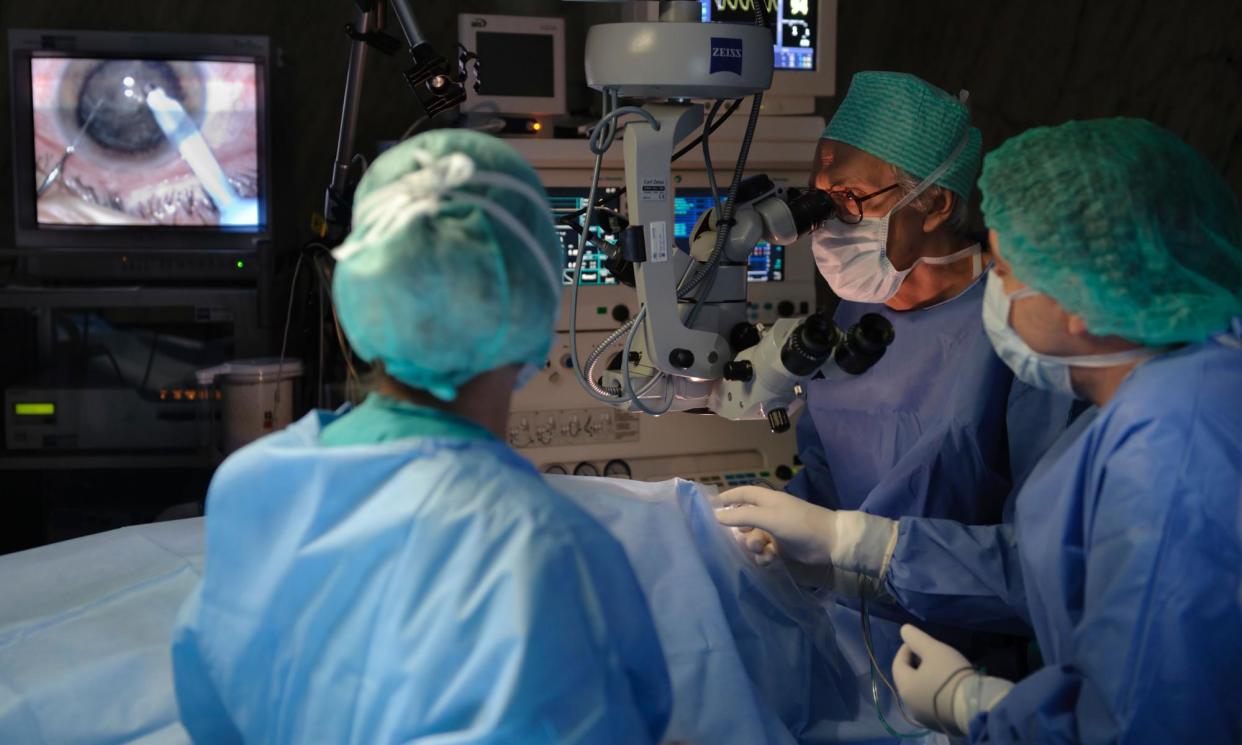 <span>Surgeons perform a cataract removal operation. </span><span>Photograph: Sergio Azenha/Alamy</span>