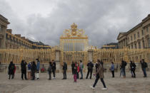 People lining up along the Gate of Honor to visit the Chateau de Versailles, west Paris, Sunday, June 7, 2020. The Chateau de Versailles was reopened on June 6, after Covid-19 closure. (AP Photo/Michel Euler)
