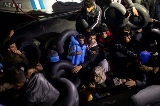 Migrants and refugees are seen on an inflatable boat during a rescue operation near the Greek island from Samos in November 2019