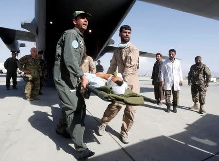 Afghan Air Force medical personnel carry an injured member of the Afghan security forces off a C-130 military transport plane in Kabul, Afghanistan July 9, 2017. REUTERS/Omar Sobhani