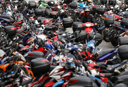 A motorcyclist looks for a lot at a carpark in Malaysia's southern city of Johor Bahru April 26, 2017. REUTERS/Edgar Su