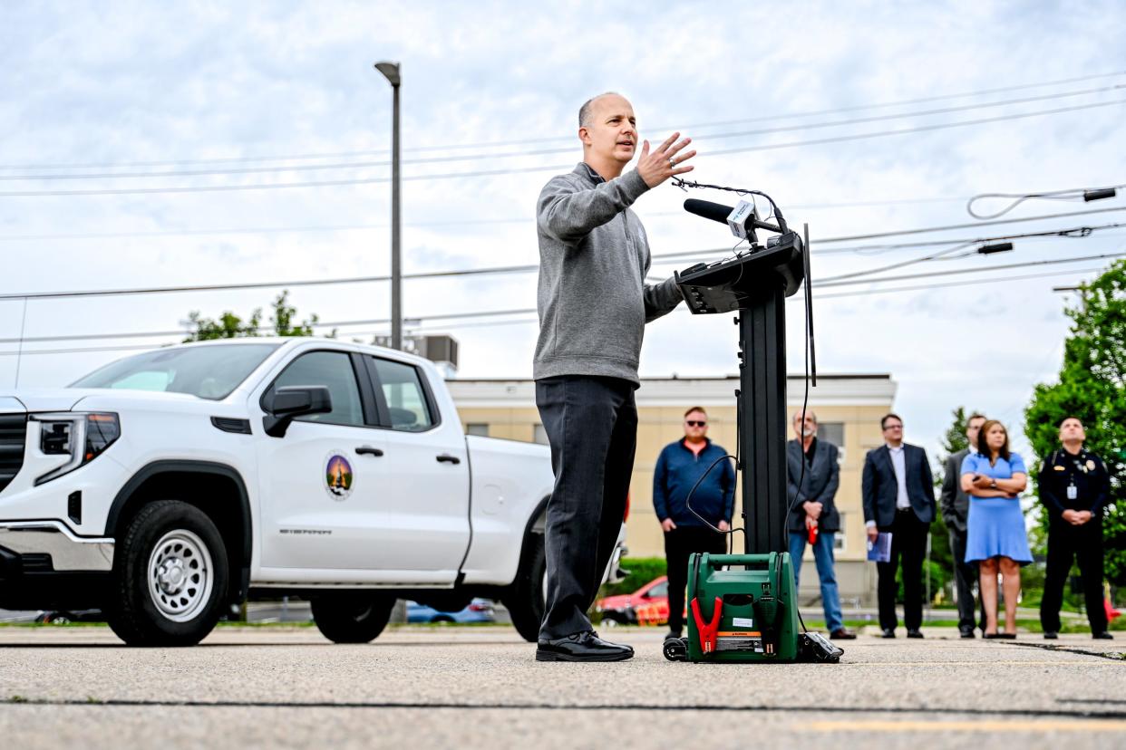 Mayor Andy Schor speaks during a press conference at the proposed site of city hall in a parking lot on Grand Avenue across from CATA's downtown transportation center on Thursday, May 9, 2024, in Lansing.