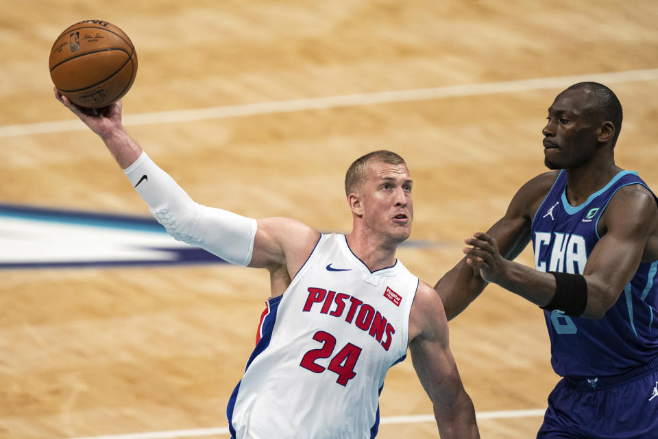 Detroit Pistons center Mason Plumlee (24) drives to the basket past Charlotte Hornets center Bismack Biyombo during the first half of an NBA basketball game in Charlotte, N.C., Thursday, March 11, 2021. (AP Photo/Jacob Kupferman)