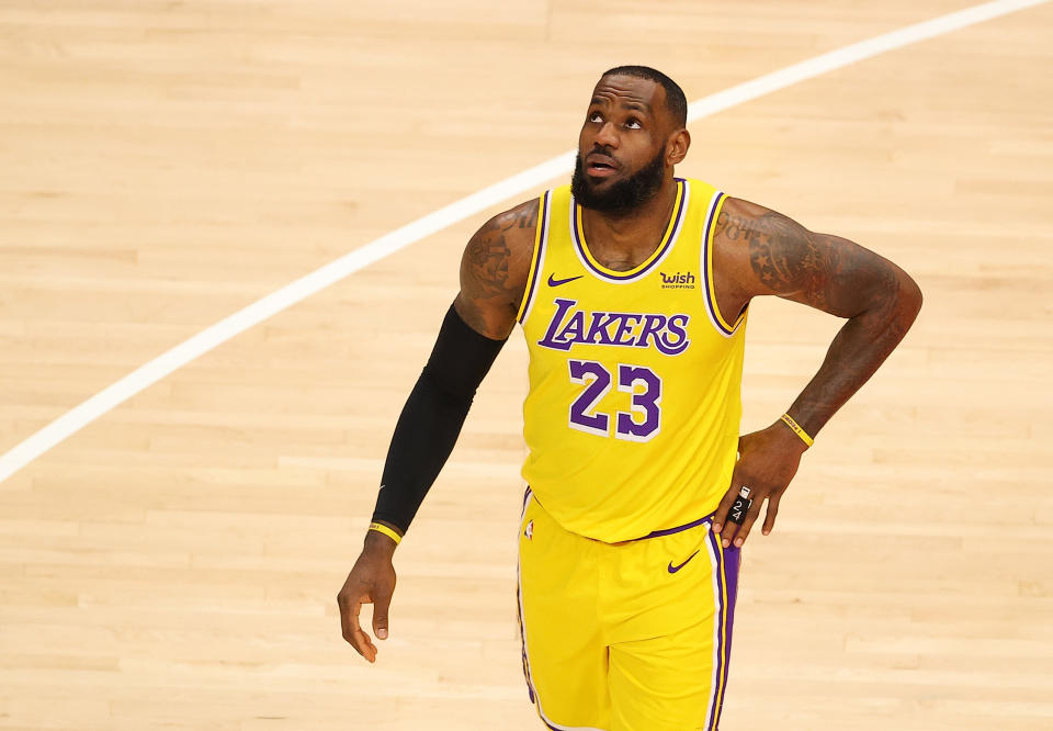 ATLANTA, GEORGIA - FEBRUARY 01:   LeBron James #23 of the Los Angeles Lakers reacts after drawing a foul from Cam Reddish #22 of the Atlanta Hawks during the first half at State Farm Arena on February 01, 2021 in Atlanta, Georgia.  NOTE TO USER: User expressly acknowledges and agrees that, by downloading and or using this photograph, User is consenting to the terms and conditions of the Getty Images License Agreement.  (Photo by Kevin C. Cox/Getty Images)