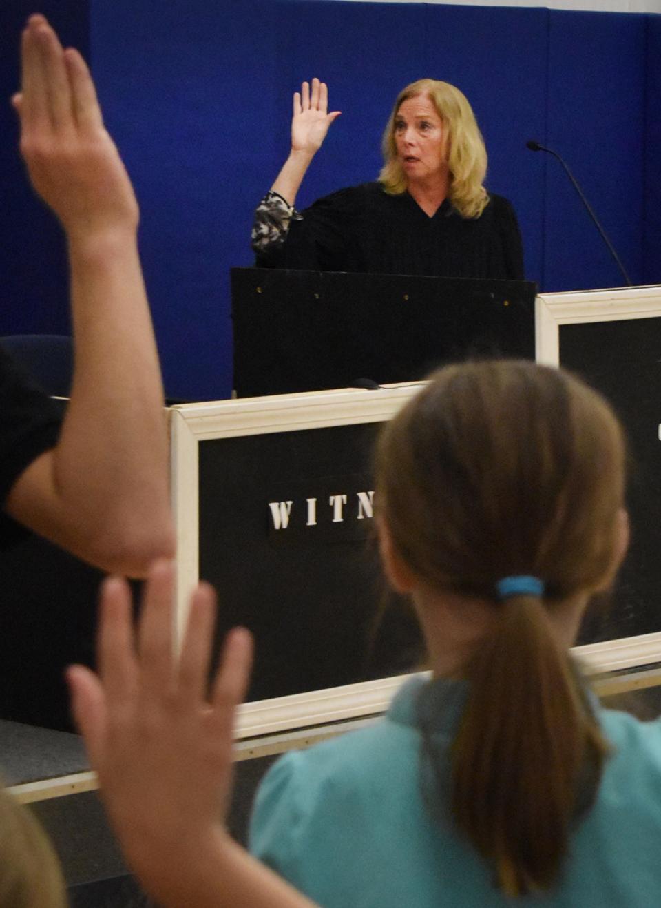 Retired presiding New Bedford District Court Judge Bernadette Sabra swears in the jury during the mock trial Thursday in Fall River.