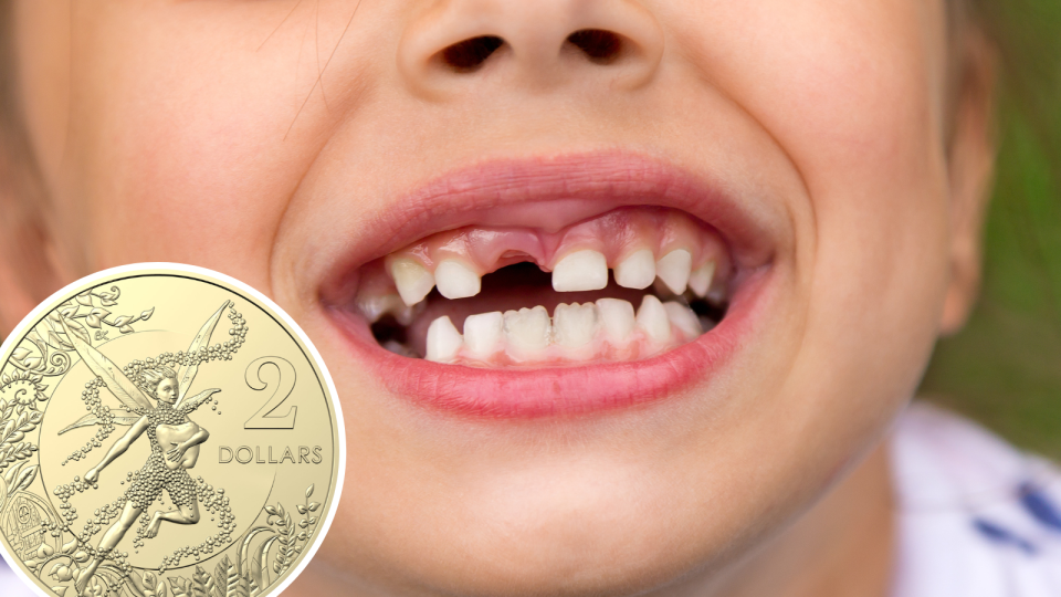 The tooth fairy commemorative coin and a child smiling missing a front tooth.