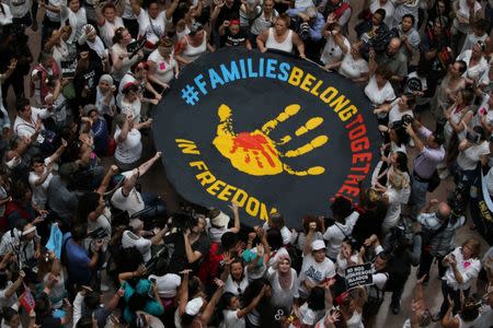 Immigration activists rally inside the Hart Senate Office Building after marching to Capitol Hill in Washington, U.S., June 28, 2018. REUTERS/Jonathan Ernst