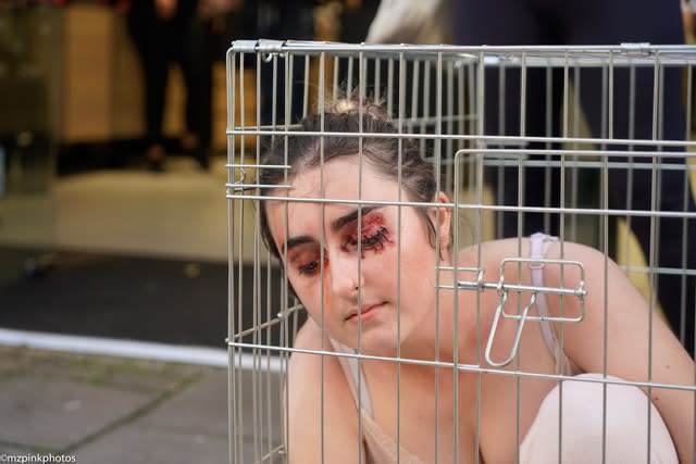 An activist takes part in a Mac Cosmetics protest in Brighton