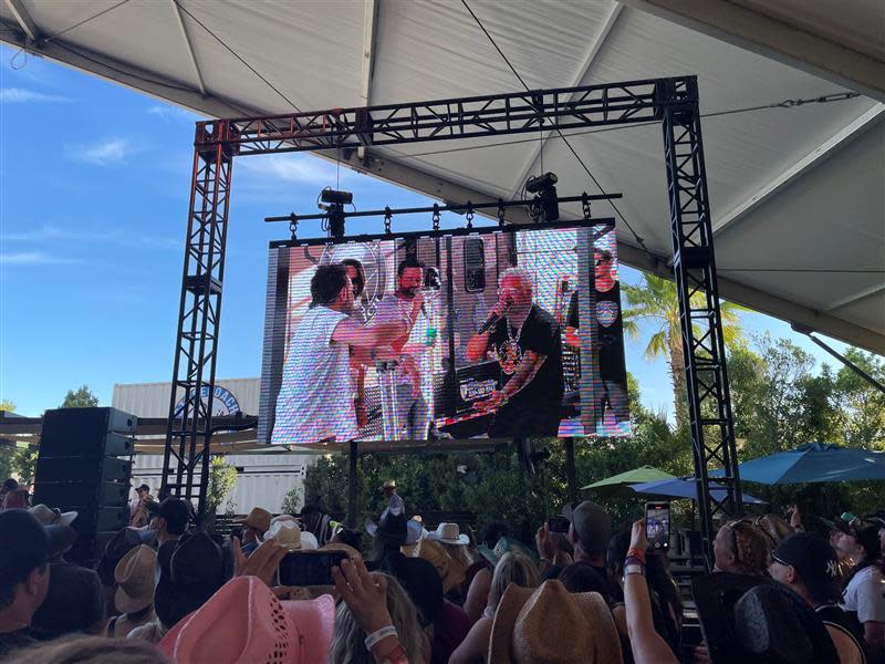 Guy Fieri, right, holds a Stagecoach Smokehouse cooking demo with the band Old Dominion on Saturday.