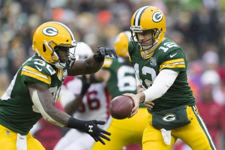 Dec 2, 2018; Green Bay, WI, USA; Green Bay Packers quarterback Aaron Rodgers (12) hands the football off to running back Jamaal Williams (30) during the third quarter against the Arizona Cardinals at Lambeau Field. Mandatory Credit: Jeff Hanisch-USA TODAY Sports