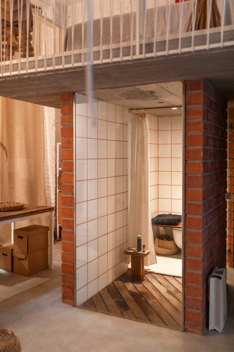 Tile and brick shower area in loft apartment