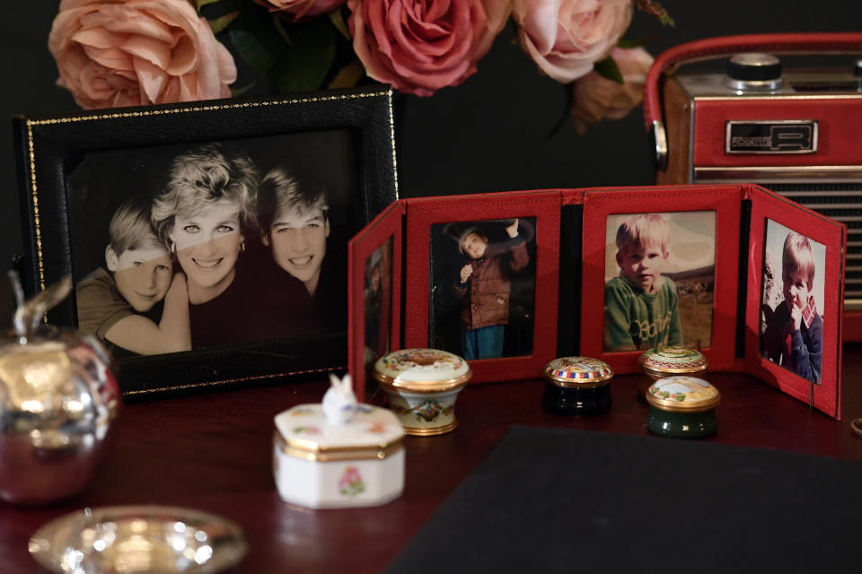 Photos of Princes William and Harry sit atop the desk Princess Diana used at Kensington Palace. (Photo: Carl Court via Getty Images)