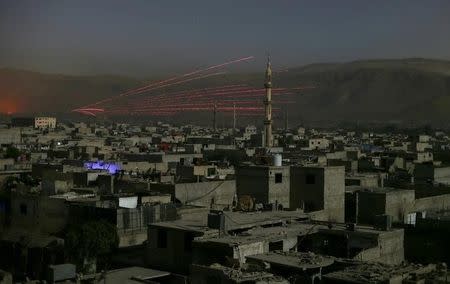 A fire trail is seen during clashes between forces loyal to Syria's President Bashar al-Assad and the Army of Islam fighters, on the eastern mountains of Qalamoun overlooking the town of Douma, eastern Ghouta, near Damascus, Syria October 1, 2015. REUTERS/Bassam Khabieh