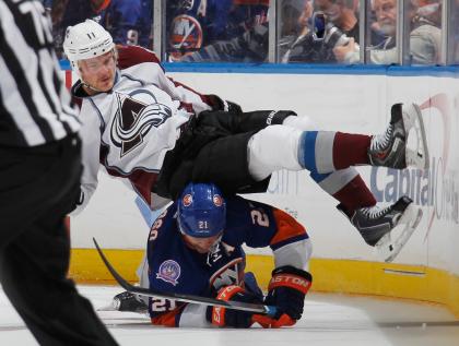 UNIONDALE, NY - NOVEMBER 11: Kyle Okposo #21 of the New York Islanders upends Jamie McGinn #11 of the Colorado Avalanche during the third period at the Nassau Veterans Memorial Coliseum on November 11, 2014 in Uniondale, New York. The Islanders shutout the Avalanche 6-0. (Photo by Bruce Bennett/Getty Images)