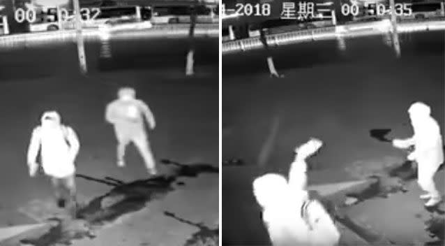 The thieves can be seen arriving before one throws a brick through the store's window. Source: Weibo/ Shanghai Municipal Police