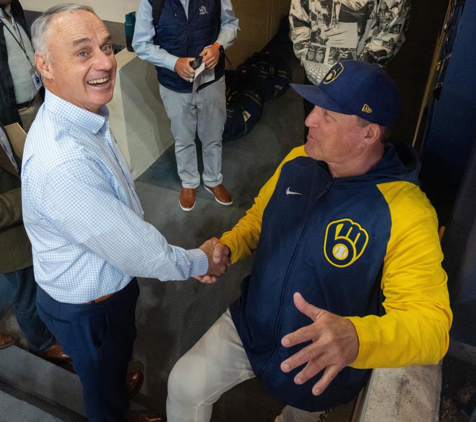 Major League Baseball commissioner Rob Manfred, left, speaks to Milwaukee Brewers bench coach Pat Murphy before their game against the San Francisco Giants Thursday, May 25, 2023 at American Family Field in Milwaukee, Wis.