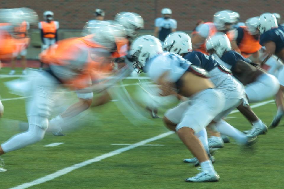 University of New Hampshire football players clash before a inter squad scrimmage Tuesday, Aug. 16, 2022 in Durham.