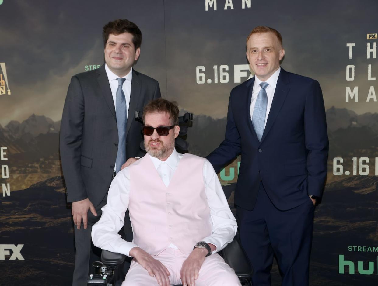 Kenneth Mitchell is shown at a Los Angeles event on June 8, 2022 for the series The Old Man, along with executives Dan Shotz, left, and Jonathan E. Steinberg, right. (Tomasso Boddi/Getty Images - image credit)