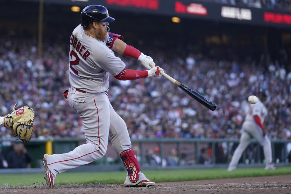 Boston Red Sox's Justin Turner hits a two-run single against the San Francisco Giants during the ninth inning of a baseball game in San Francisco, Saturday, July 29, 2023. (AP Photo/Jeff Chiu)