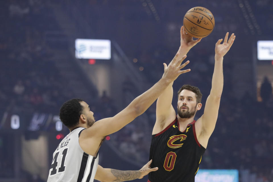 Cleveland Cavaliers' Kevin Love (0) passes over San Antonio Spurs' Trey Lyles (41) in the first half of an NBA basketball game, Sunday, March 8, 2020, in Cleveland. (AP Photo/Tony Dejak)