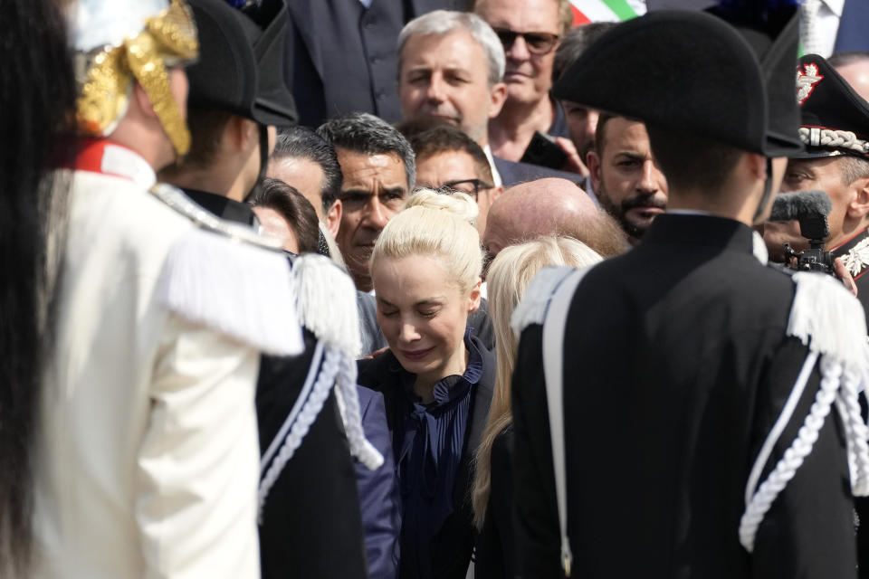 Marta Fascina, partner of former Italian premier Silvio Berlusconi, is comforted as the casket of Berlusconi leaves Milan's duomo Gothic-era Cathedral at the end of his state funeral, Italy, Wednesday, June 14, 2023. Berlusconi died at the age of 86 on Monday in a Milan hospital where he was being treated for chronic leukemia. (AP Photo/Antonio Calanni)